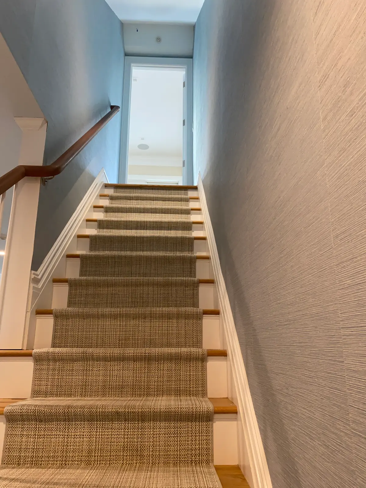 grasscloth wallpaper installation in a Manhasset staircase