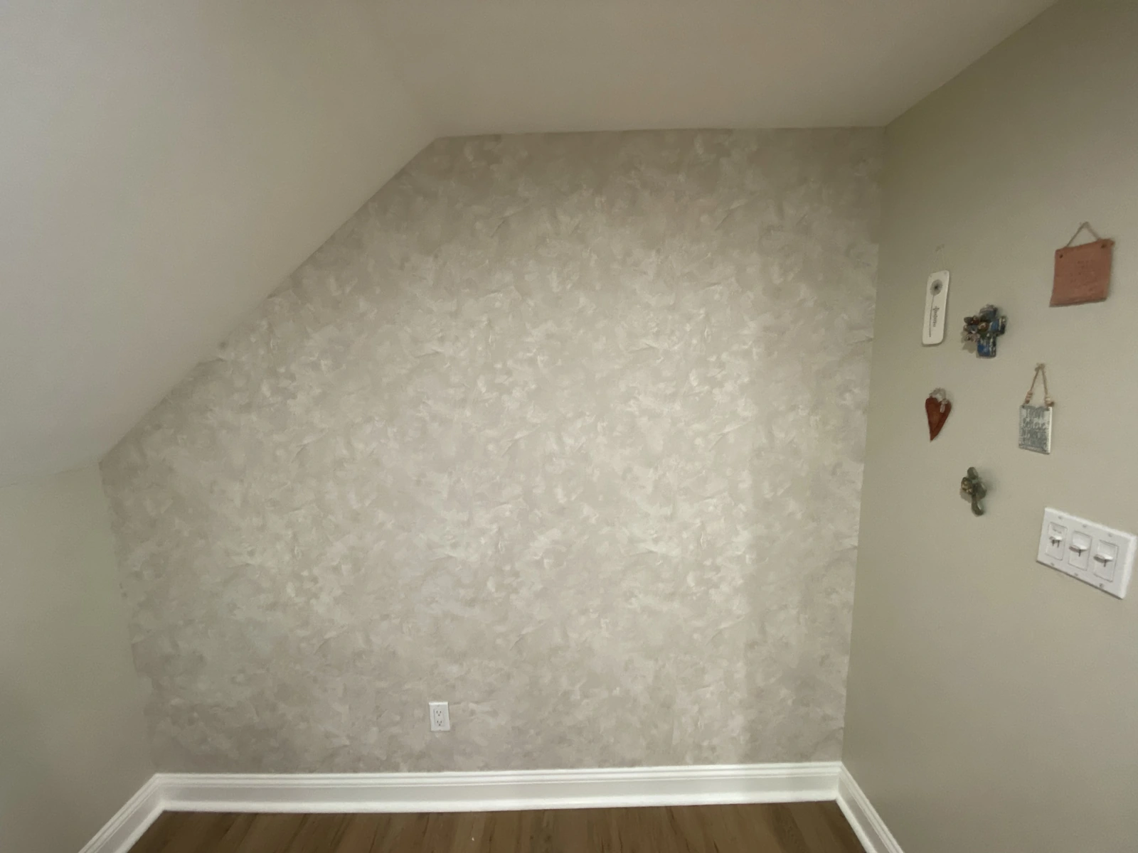 textured wallpaper installed on a sloped-ceiling wall in a Long Island living room