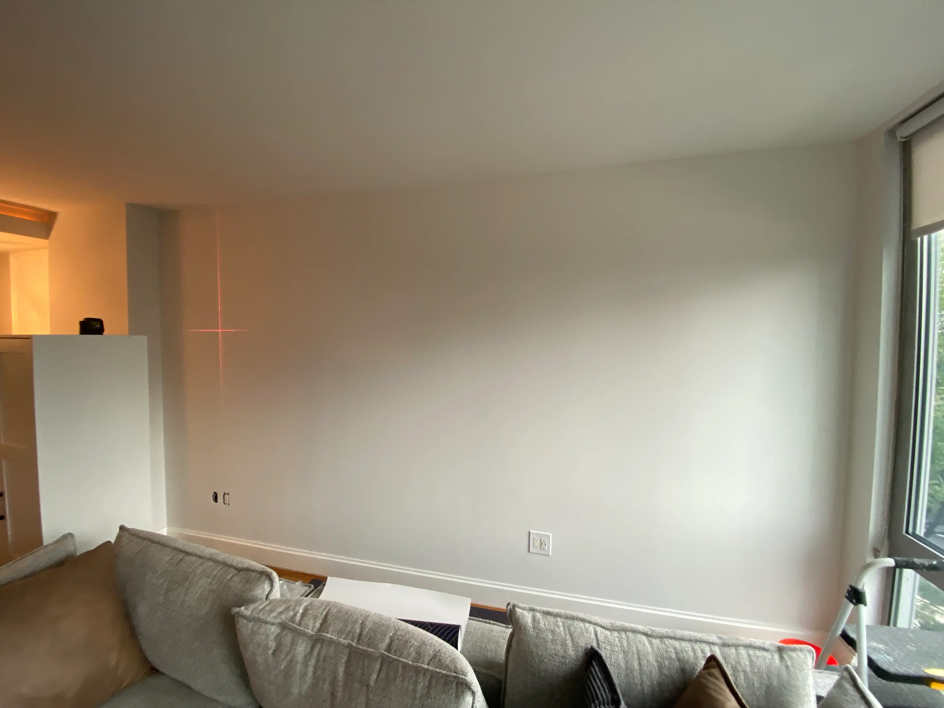 bare living room wall in Brooklyn, NY before the peel & stick accent wall