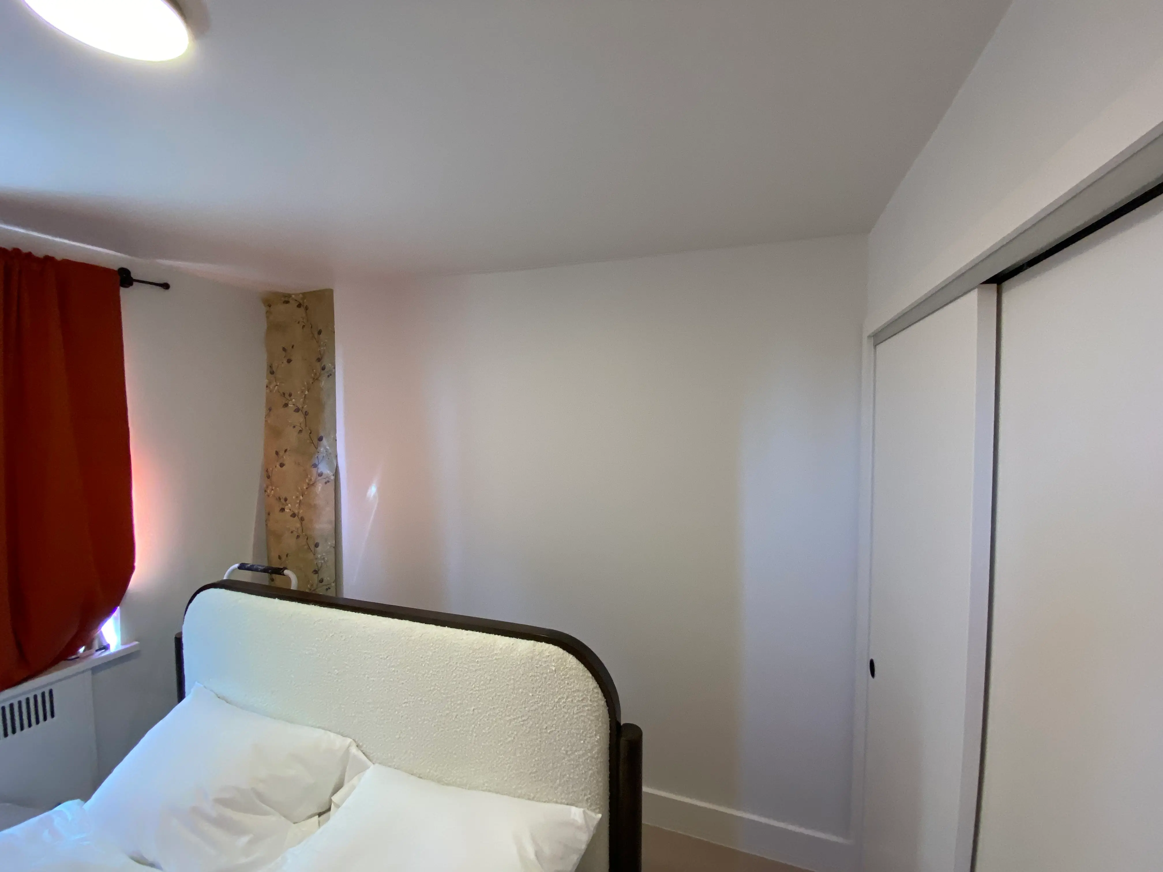 bare bedroom wall in Lower Manhattan, NY before the peel & stick wallpaper