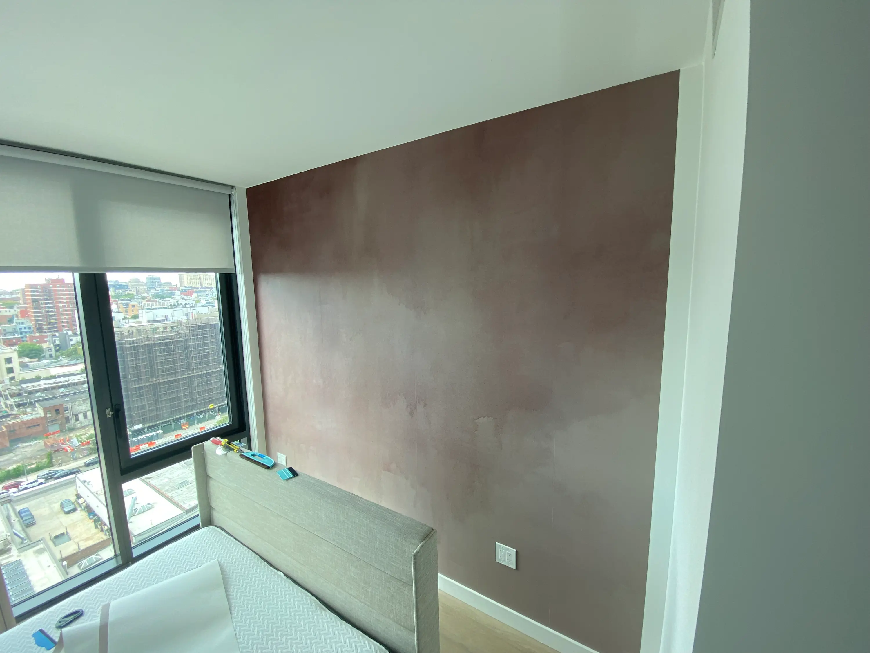 terracotta ombre mural wallpaper behind the bed in a Brooklyn, NY bedroom