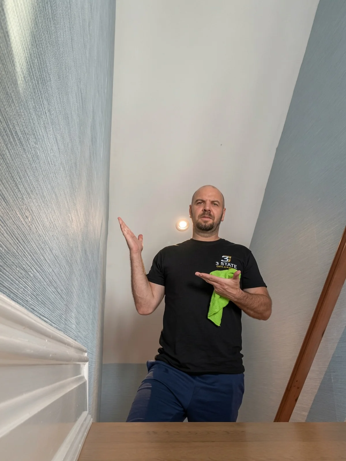 wallpaper installer finishing a staircase in a Hoboken home